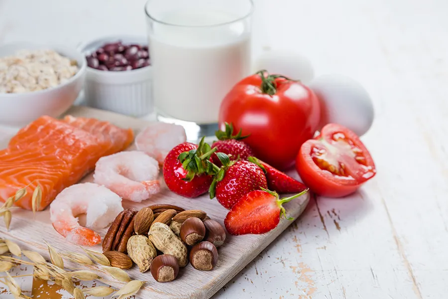 A board of foods like nuts, shellfish, and dairy, that are commonly associated with allergies. Get treatment for food allergies from Dr. Bahar Amin in North York.