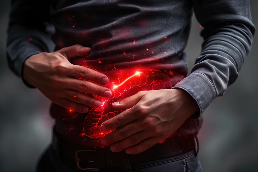 A man clutches his abdomen, with a digital illustration of inflamed intestines glowing in red. Dr. Bahar Amin offers advanced inflammatory bowel disease (IBD) treatment in North York using functional medicine and gut-focused therapies.