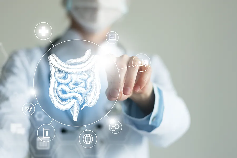 Dr. Bahar Amin provides advanced Functional Medicine for Leaky Gut Syndrome treatments in North York, shown by a doctor touching a glowing digital intestinal health display.