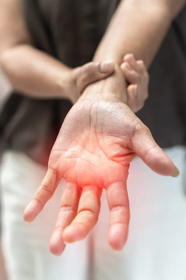 A blond, middle-aged woman looks out the window with a tired expression. Schedule chronic fatigue treatment from Dr. Bahar Amin in North York.
